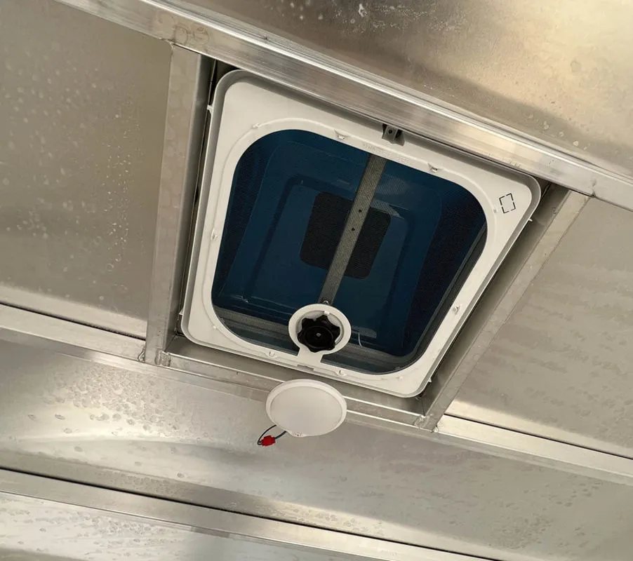 2023 High Country 14 ft Trailer – Blue, Drive-Through – Interior ceiling view showing an adjustable vent and a small circular LED light