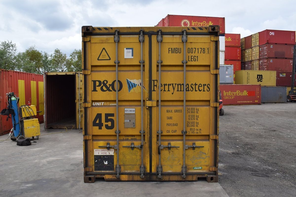45ft High Cube Pallet Wide Container – Used, Cargo Worthy – closed yellow container cargo doors in a stacked container yard