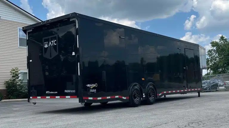 2026 ATC 40 ft Gooseneck – Black Trim – Rear three-quarter view of the black trailer showing the ramp door and wheels