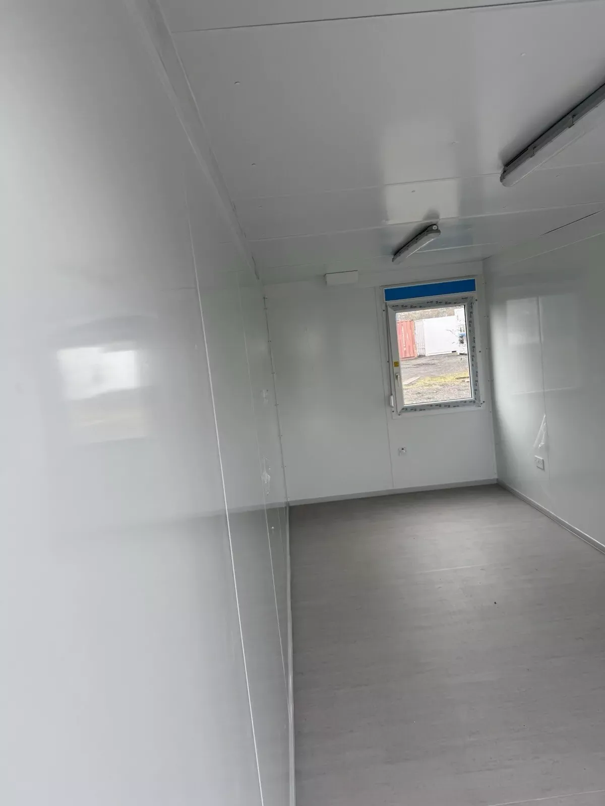 20ft Modular Container Office – Insulated Steel Workspace – empty office interior with white walls and gray flooring