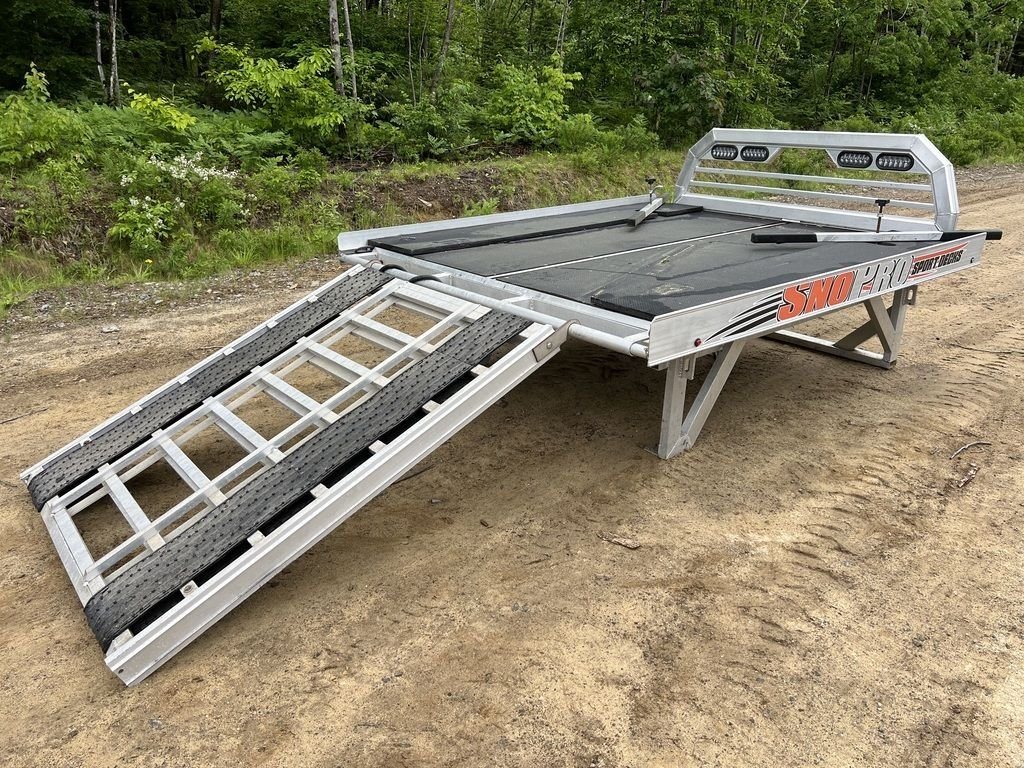 2022 Sno Pro 7 ft Sled Deck – Quad Ply Decking – Side angle of the sled deck with the ramp extended to the dirt