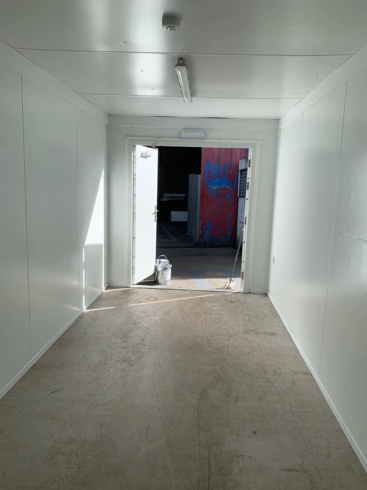20ft Insulated Storage Container – Steel Lock Boxes – Empty insulated interior with white panels and open doorway