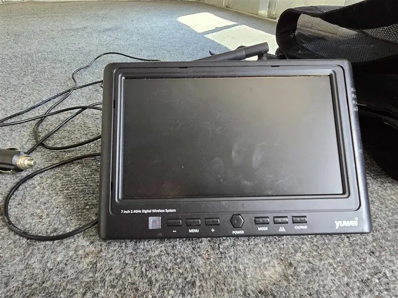 2000 C&C 2 Horse Gooseneck Trailer – Aluminum, Dressing Room – Electronic digital wireless monitor for the trailer camera system resting on carpet