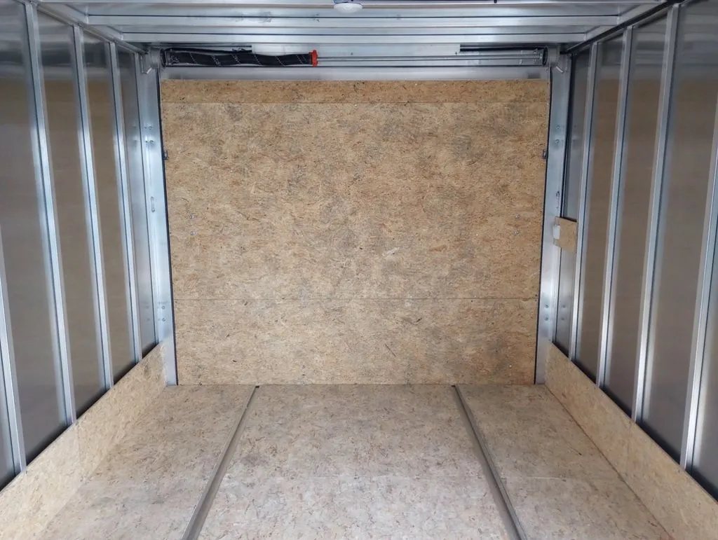 2024 Mission Trailers 12 ft Powersports – Side X Side – Looking towards the front wall inside the empty trailer showing metal wall studs