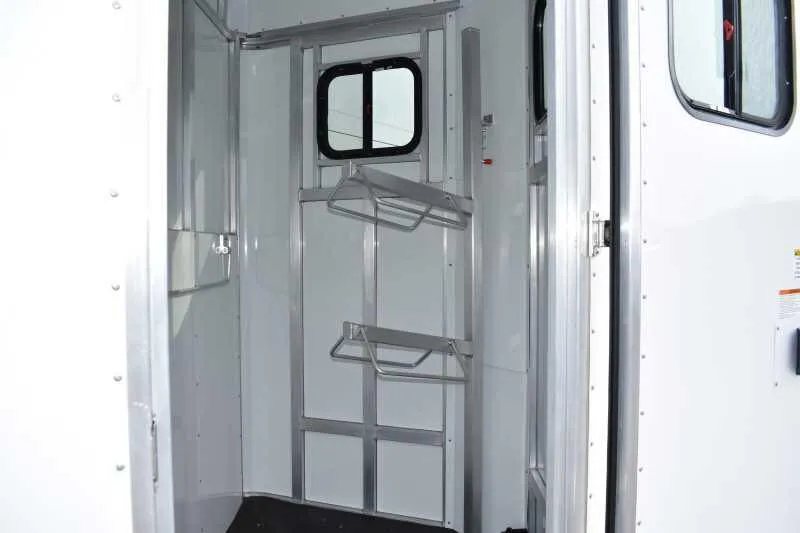 2019 Trailers USA 2 Horse Trailer – Aluminum, Dressing Room – Tack room interior with saddle racks and a small window for ventilation