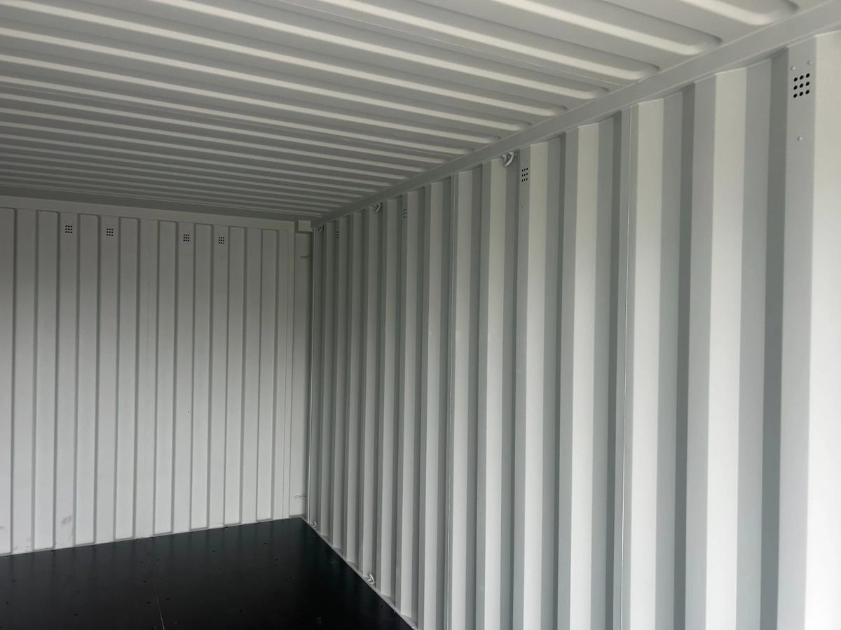 20ft New Shipping Container – One-Trip, Double Doors – empty container interior with corrugated walls and dark floor