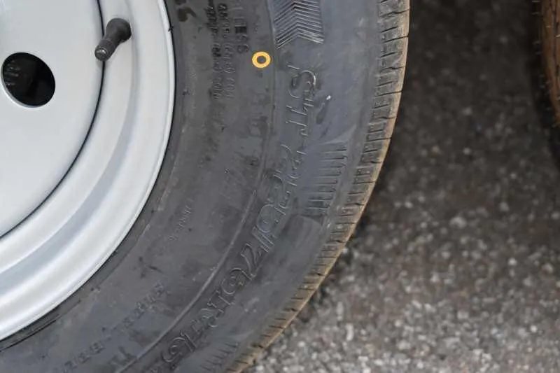 2019 Trailers USA 2 Horse Trailer – Aluminum, Dressing Room – Close-up view of a trailer tire showing the tread and sidewall text