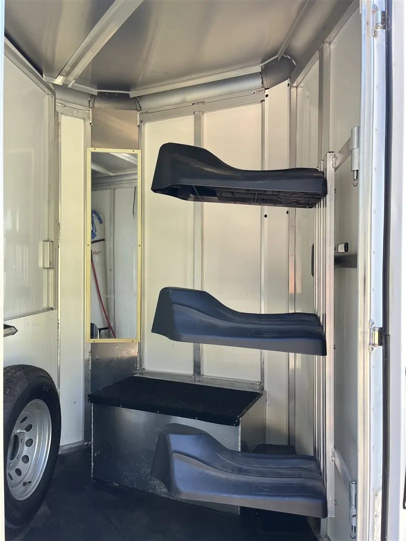 2013 Sundowner Sportsman 3 Horse Trailer – Extra-Large Tack Room – A three tier saddle rack and a mirror inside the trailer tack compartment