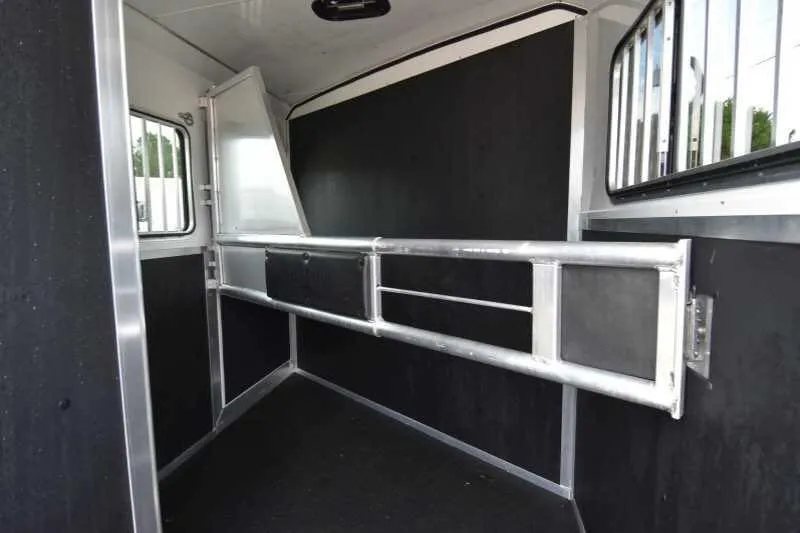 2016 Shadow 2HBP 2 Horse Bumper Pull Trailer – Aluminum – Interior stall area of horse trailer with metal divider and rubber matting