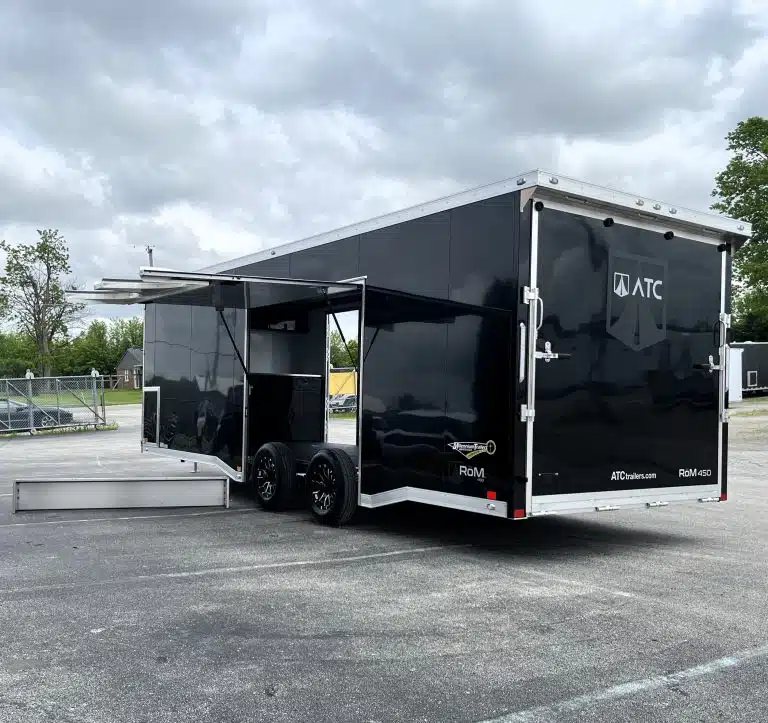 2026 ATC 24 ft Car Hauler – ROM 450, LifeTrac – Rear and side view of black enclosed trailer with large open escape door