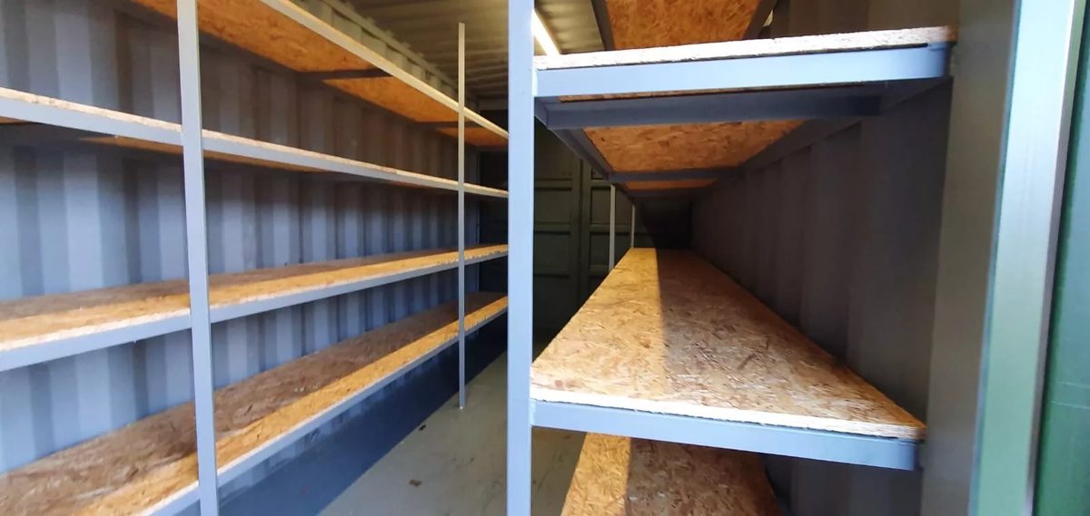 20ft High Cube Storage Container – Lighting and Shelving – container interior with wooden shelving along both sides