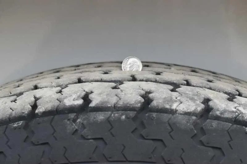 2016 Shadow 2HBP 2 Horse Bumper Pull Trailer – Aluminum – Close up of tire tread depth with a coin for scale