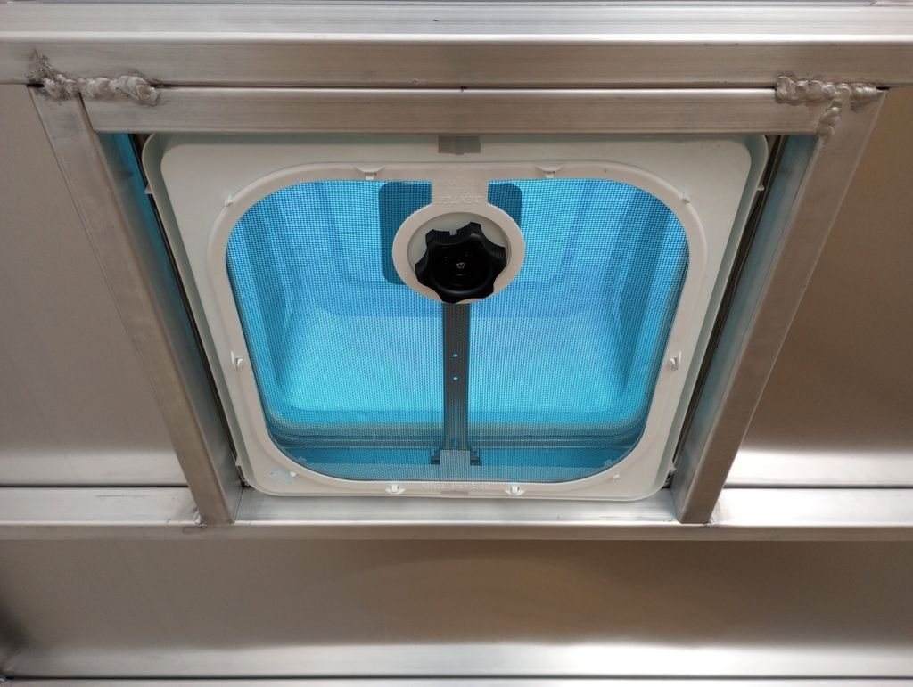 2024 Mission Trailers 24 ft Deckover – Galvanized Package – Close-up of a square manual crank roof vent from the interior