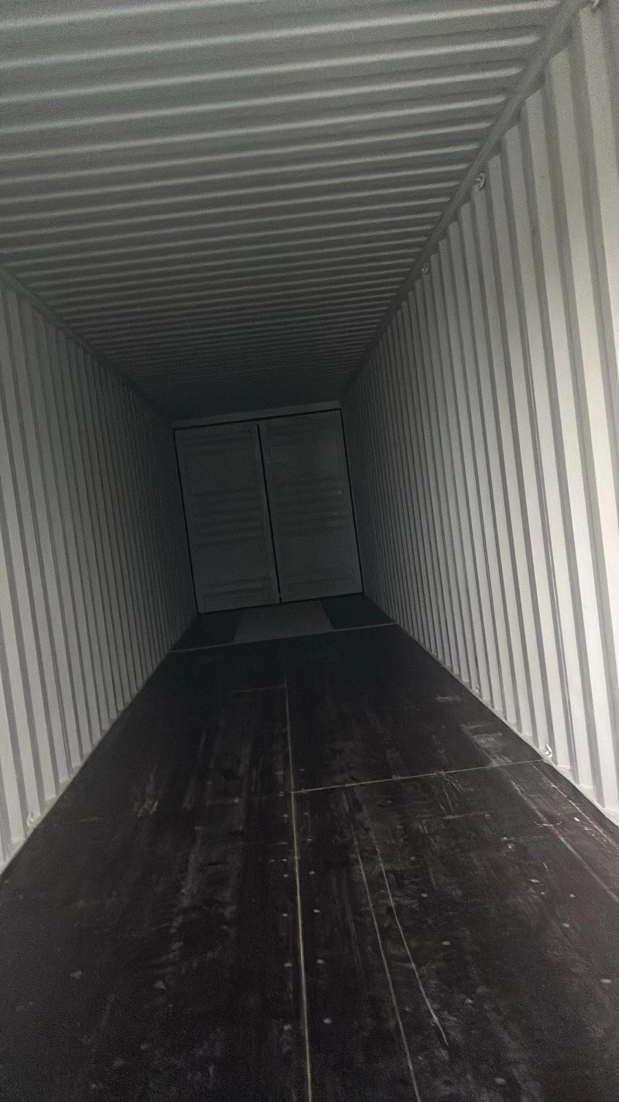 40ft High Cube Shipping Container – New / One-Trip – empty container interior with corrugated walls and dark plywood floor