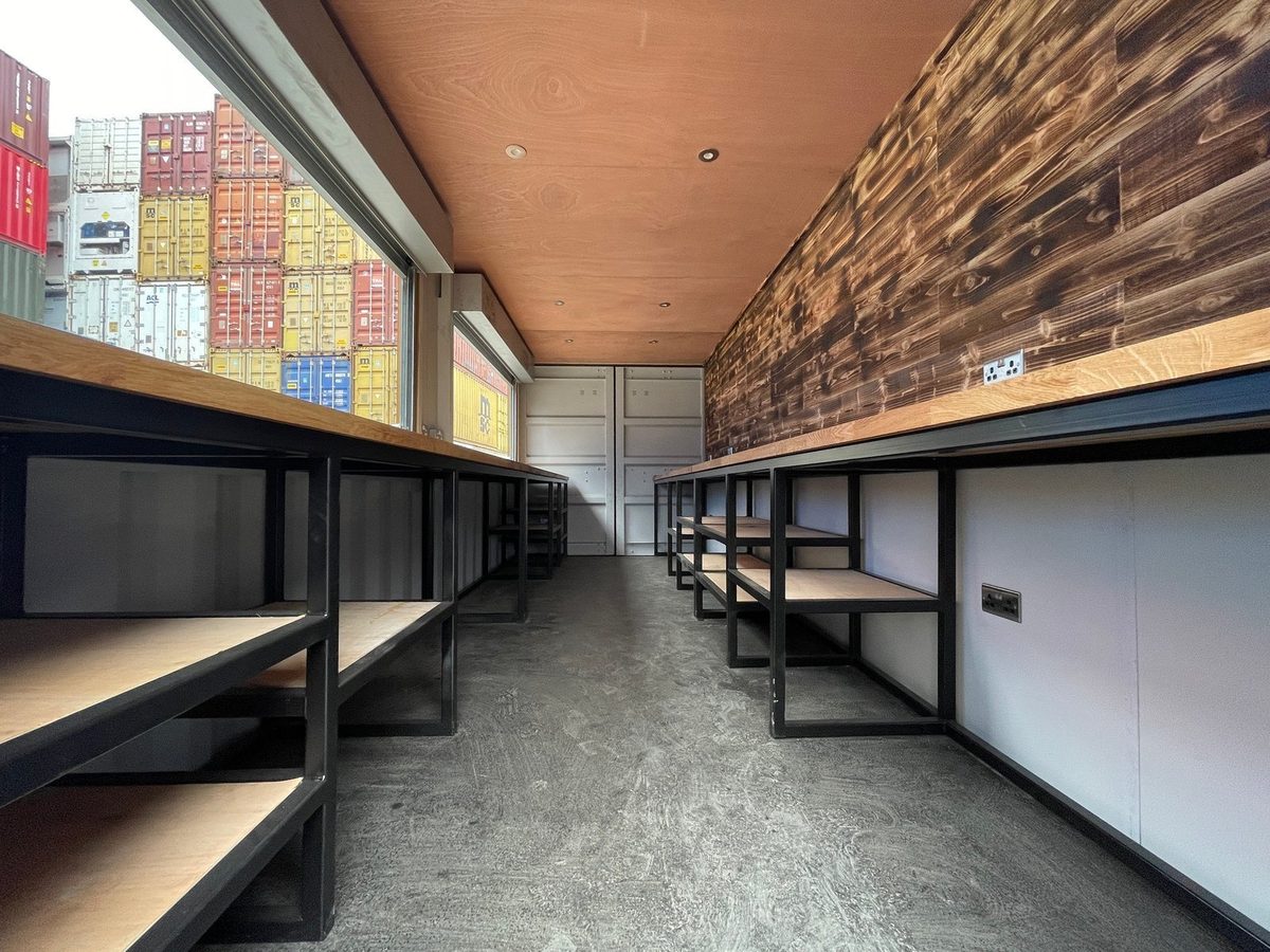 20ft High Cube Container Bar – Multiple Serving Hatches – container bar interior with wooden counters and open shelving