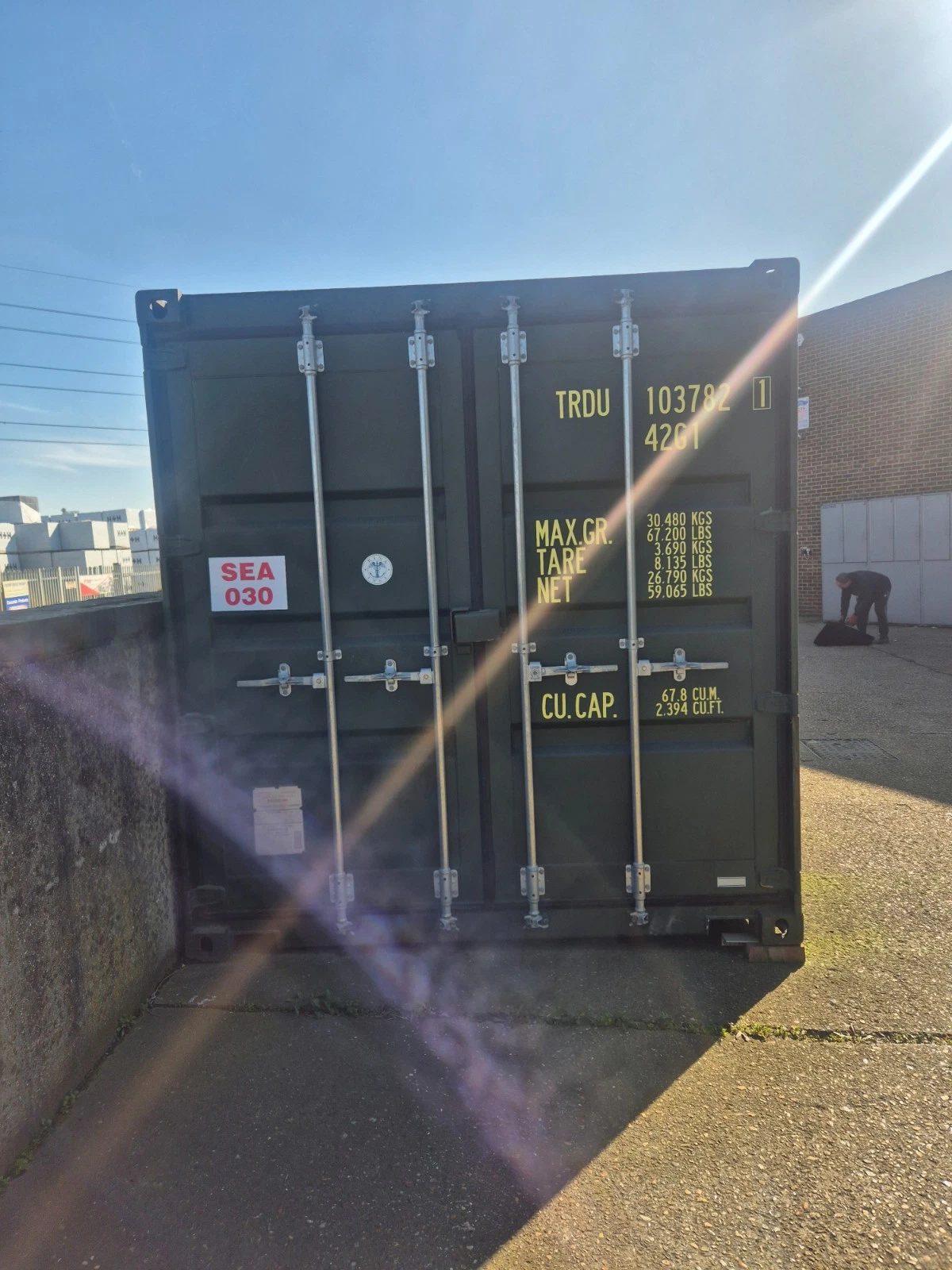 40ft One-Trip Shipping Container – Five Side Doors – front view of closed cargo doors with strong sun flare