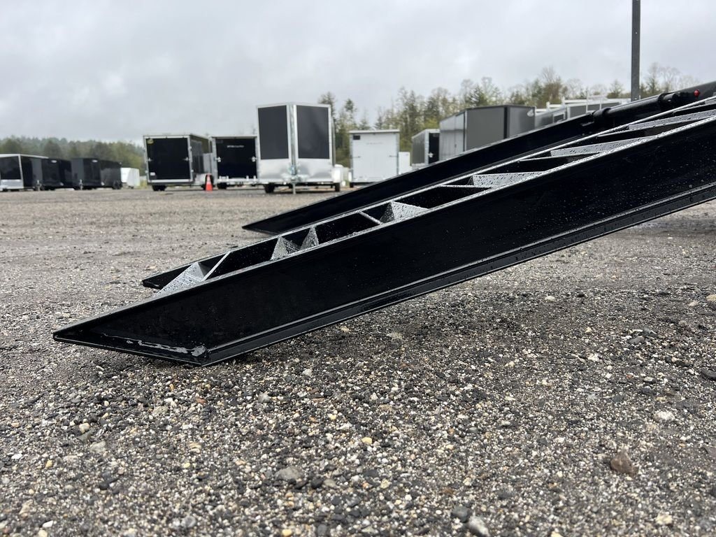 2024 Diamond C 24 ft Deckover – Blackwood Deck – Profile close up of the metal ramp structure resting on gravel