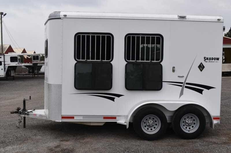 2013 Shadow 2HSL 2 Horse Trailer – Aluminum, Dressing Room – Left-side exterior view of the horse trailer featuring two barred windows and dual axles