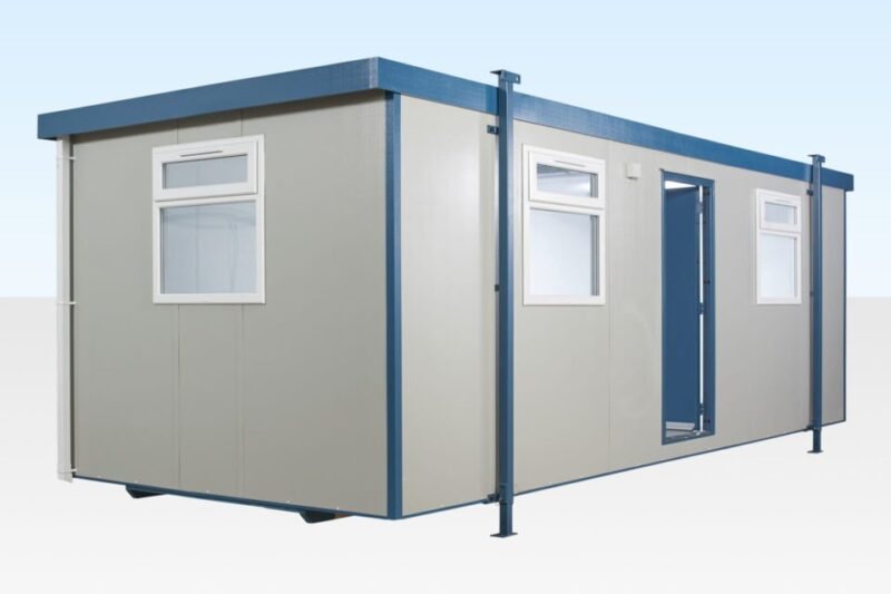 24 x 10 ft Jackleg Cabin – Goosewing Gray – Exterior three-quarter view of a grey jackleg cabin with blue trim and white windows