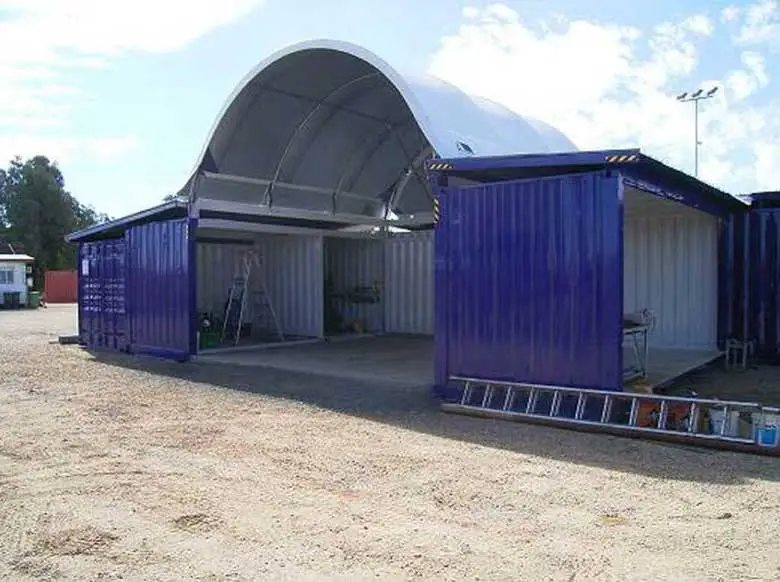 Container Shelter – Domed Tensile Membrane Cover – Blue shipping container workshop with an arched white shelter roof extension attached