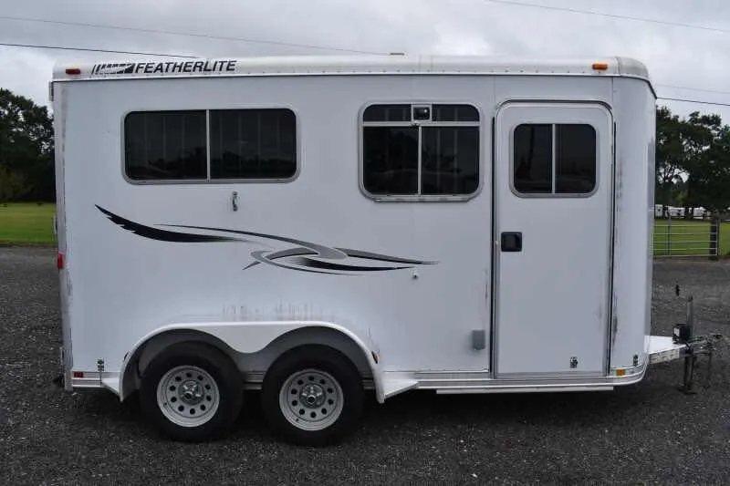 2003 Featherlite 2HST 2 Horse Trailer – Aluminum – Side view of the trailer with drop windows in the upright closed position