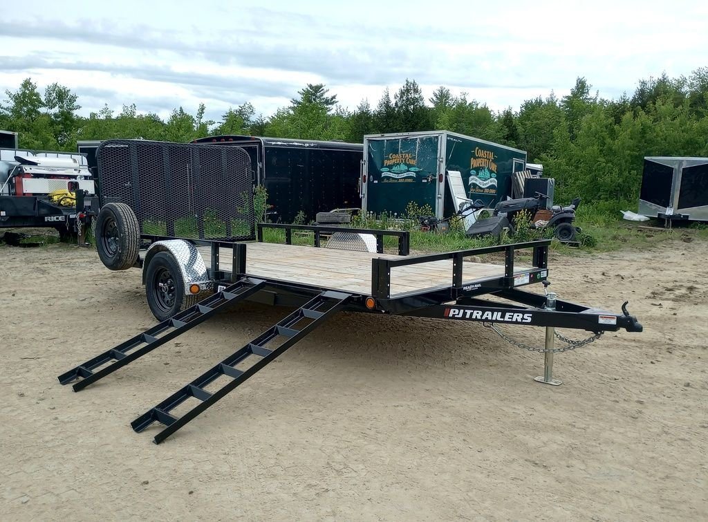 2024 PJ Trailers 14 ft Utility – Side Loading Ramps – Black utility trailer with side-loading ATV ramps deployed on a dirt lot