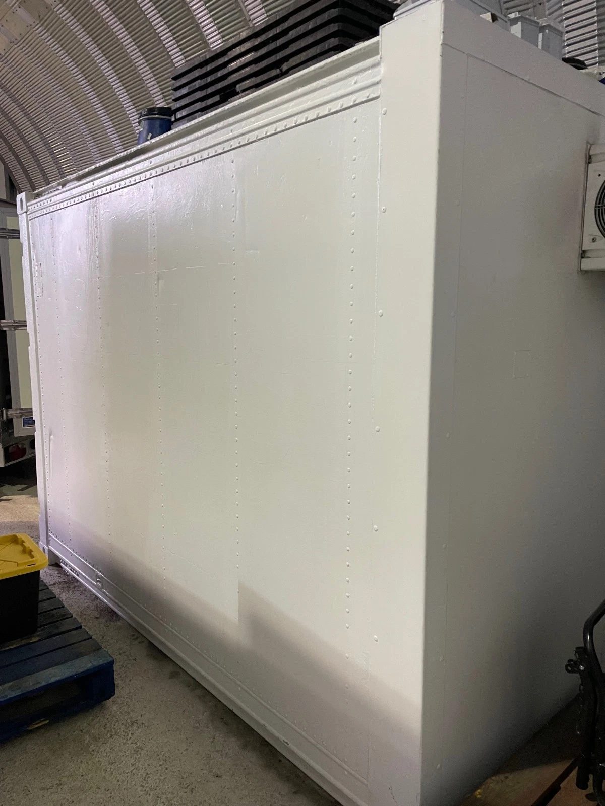 10ft Refrigerated Shipping Container – Fridge and Freezer – white refrigerated container side and corner inside a warehouse