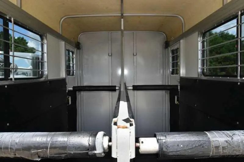 2002 Kiefer Built 2 Horse Bumper Pull – Dressing Room – Inside view of the horse stalls with padded dividers and windows