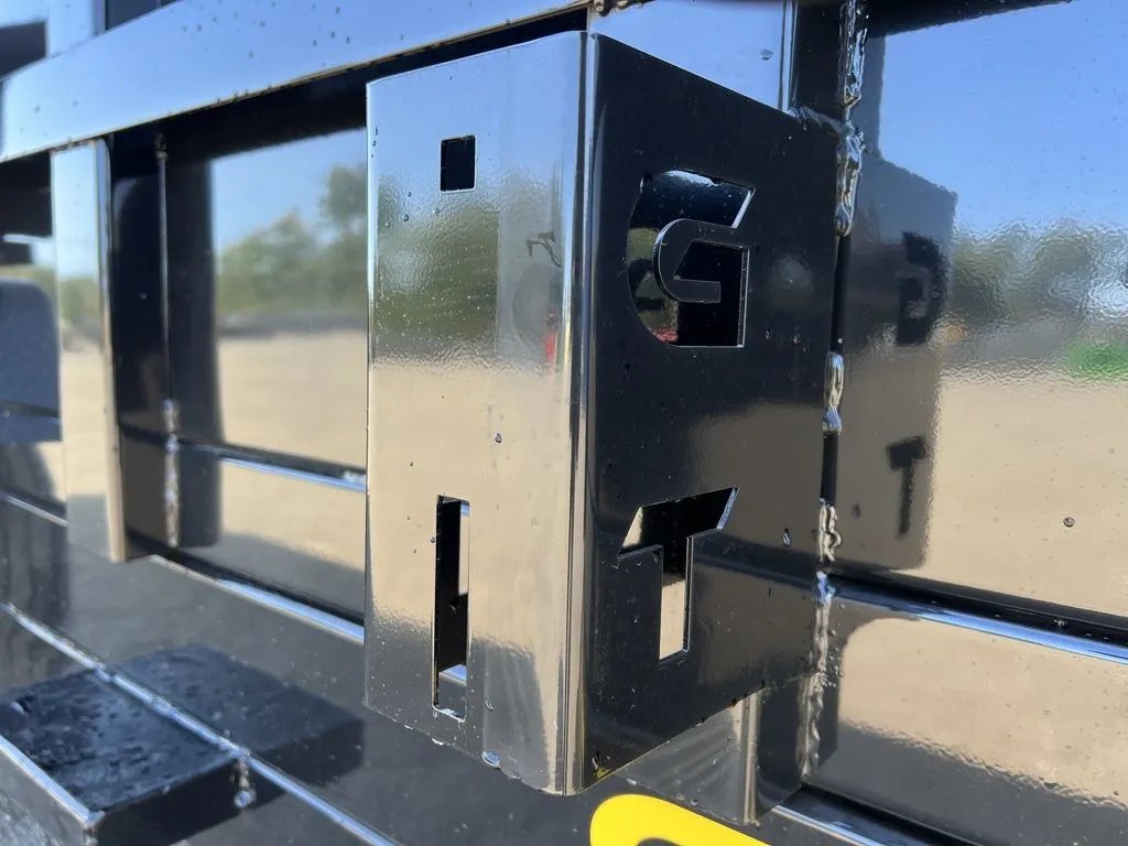 2024 Griffin Trailers 16 ft Dump Trailer – Telescopic – A close-up view of a black metal bracket with cut-out letters