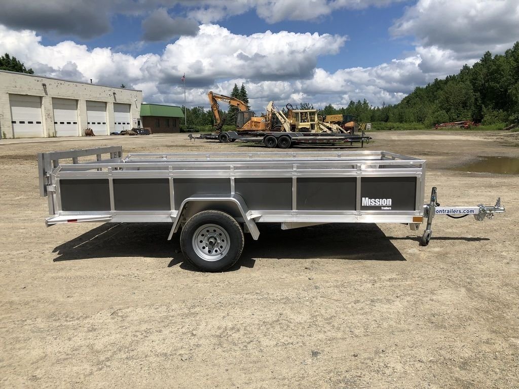2022 Mission 6 × 12 ft Utility Trailer – Rear Ramp – Side profile of the trailer from the opposite side against a cloudy sky background