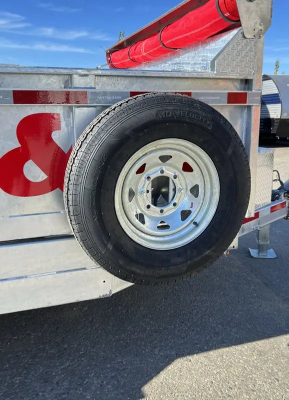 2024 N&N Trailers 14 ft Dump – Galvanized Steel – Side view of the spare tire mounted on the side of the trailer