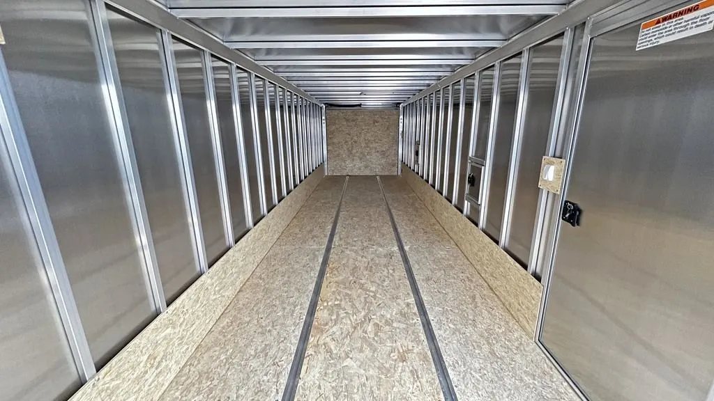 2024 E-Z Hauler 24 ft Trailer – Rear Canopy – Empty interior of the trailer showing wooden floors and aluminum wall studs