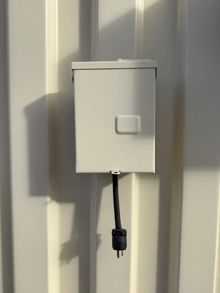 20ft Ground-Level Office Container – Insulated Workspace – exterior electrical box with hanging power cord and plug