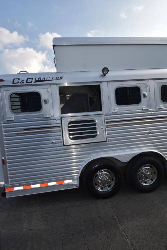 2008 C and C Trailers 4 Horse Bumper Pull – Hay Pod – Close up of the trailer wheels, axles, and silver corrugated side panels