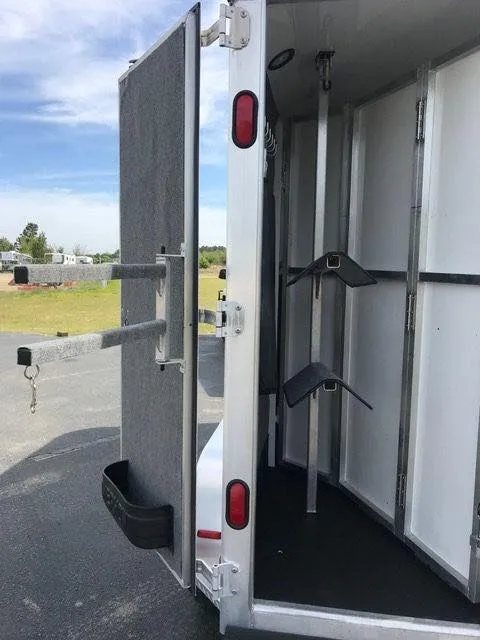 2010 Merhow 2 Horse Slant Trailer – Insulated Roof, Escape Door – Rear tack area with saddle racks and bridle hooks on an open door