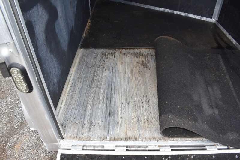 2013 Shadow 2HSL 2 Horse Trailer – Aluminum, Dressing Room – Close-up of the trailer floor with a black rubber mat partially rolled back