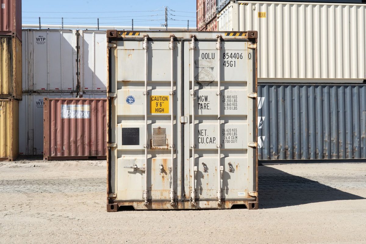 40ft Used High Cube Shipping Container – Storage Grade – closed cargo doors of weathered container in stacked storage yard