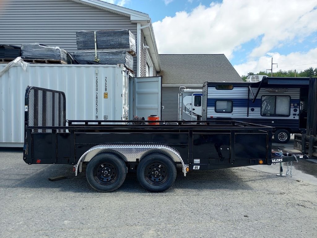 2024 PJ Trailers 14 ft Utility – Solid Metal Sides – Full side profile of the tandem axle black utility trailer with solid sides