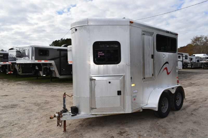 2001 CM Odyssey 2 Horse Trailer – Aluminum Floor – A three-quarter exterior view of a silver two-horse trailer on a dirt lot