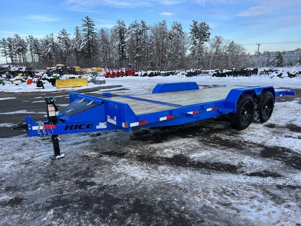2024 Rice Trailers 20 ft Tilt Trailer – Spare Mount – A blue three-quarter exterior view of a flatbed equipment trailer in a snowy lot