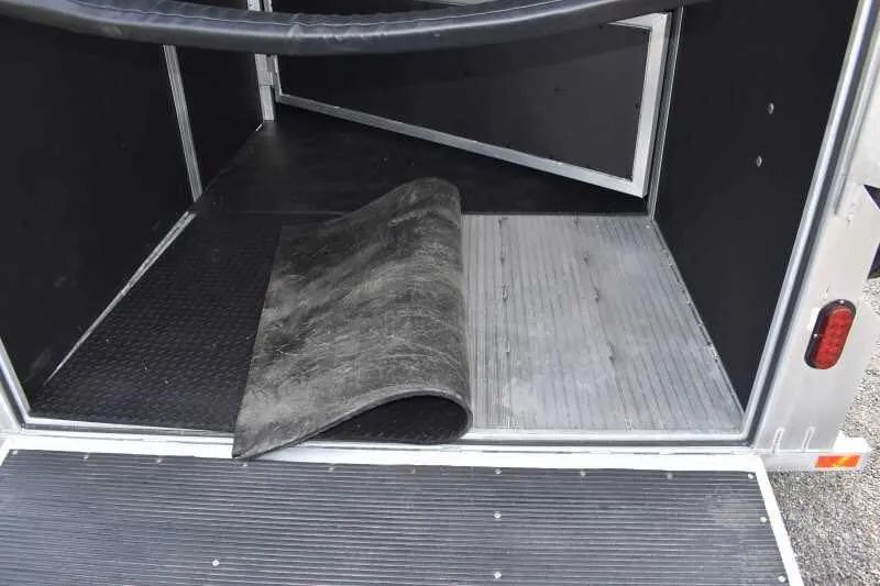 2019 Trailers USA 2 Horse Trailer – Aluminum, Dressing Room – Trailer floor with rubber mat partially lifted to show aluminum plank flooring
