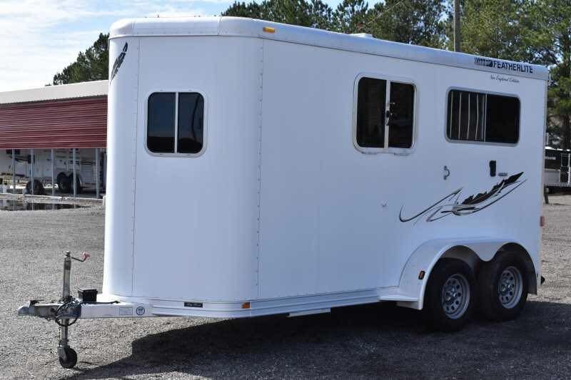 2005 Featherlite 2HST Horse Trailer – Walk-Through Dressing Room – Front three-quarter view of white horse trailer with silver hitch