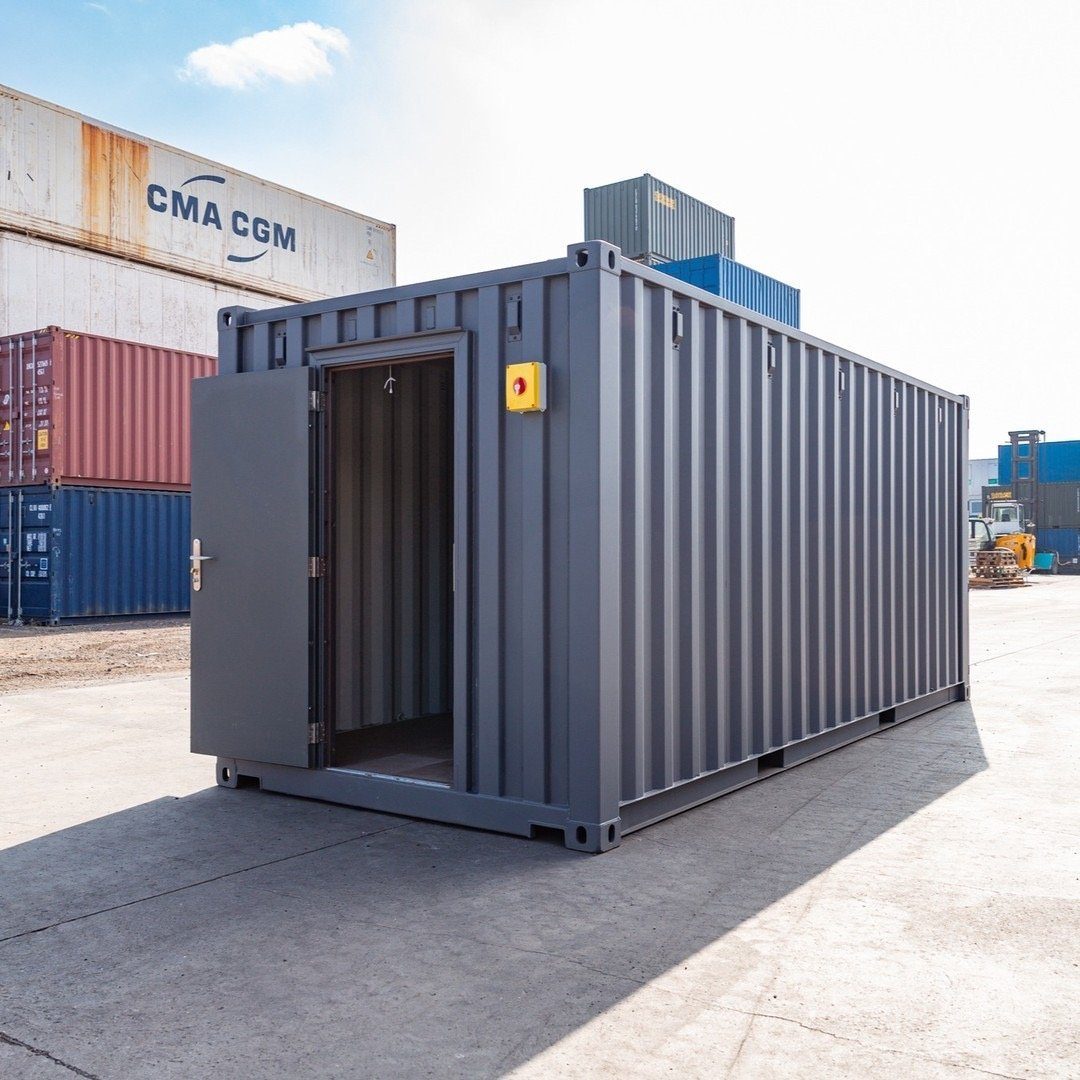 20ft Standard Shipping Container – Gray Finish, Double Doors – three-quarter exterior view of grey container with personnel door open