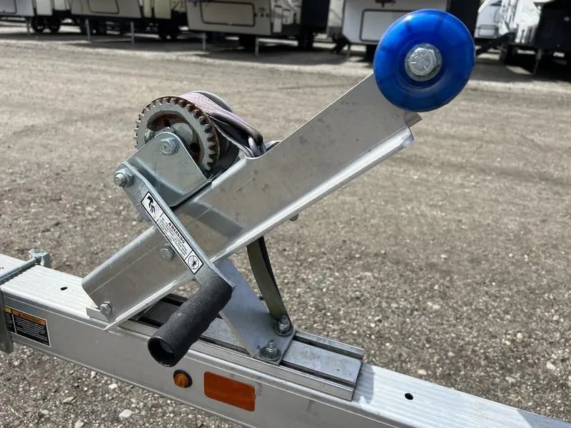 2020 Karavan Single-PWC Trailer – Aluminum, Adjustable Bunks – Detail view of the manual winch assembly with blue roller and handle