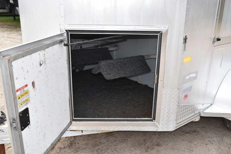 2001 CM Odyssey 2 Horse Trailer – Aluminum Floor – Looking into the open front tack storage area with saddle racks