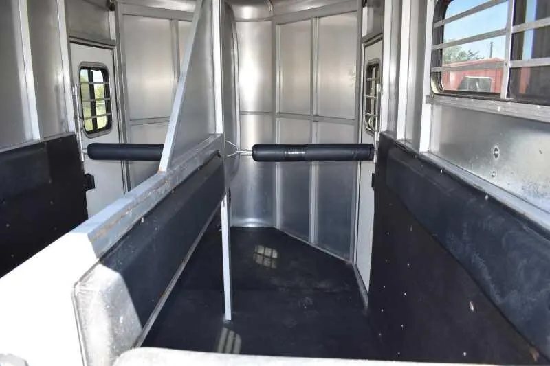 2004 Dalton 2 Horse Bumper Pull Trailer – Aluminum, Straight Load – View looking into the horse stalls with rubber floor mats and side padding