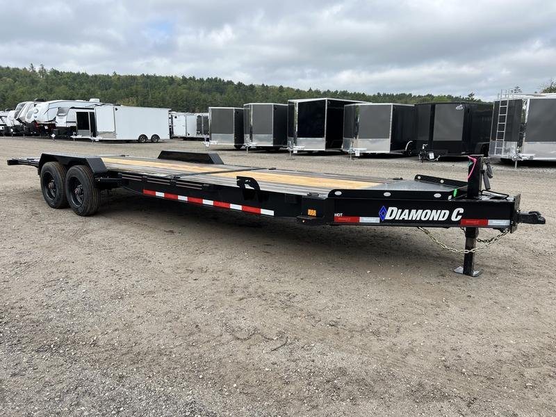 2024 Diamond C 24 ft Tilt Trailer – Spare Mount – Full length side view of the black equipment trailer on a gravel lot