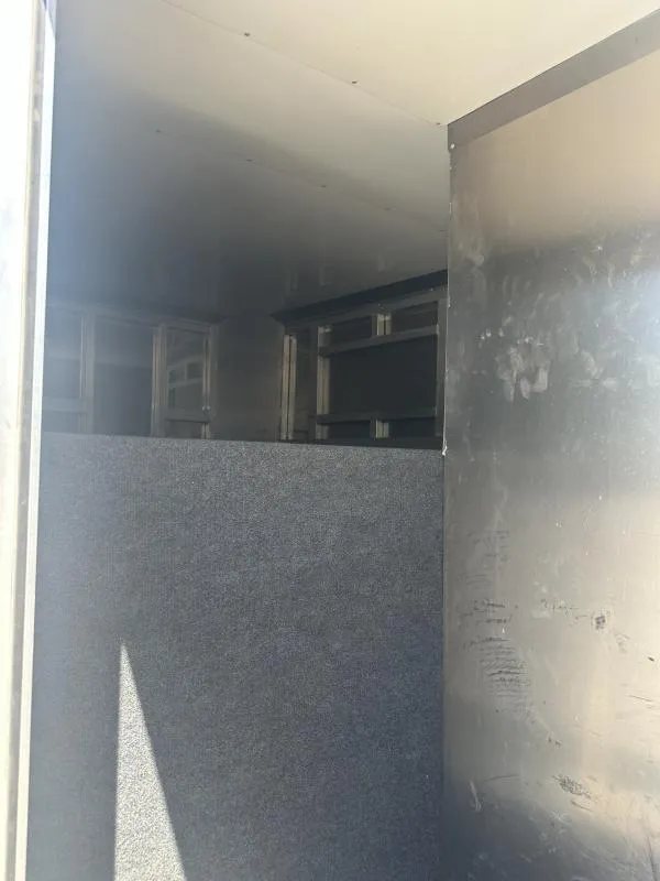 2020 Bloomer 4 Horse Stock Combo – Trainer Tack – Empty interior compartment of the trailer with carpeted wall section
