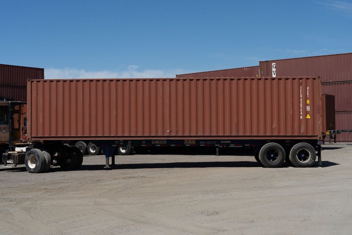 40ft Used Cargo-Worthy Shipping Container – Standard Dry Storage – side view of brown shipping container on trailer