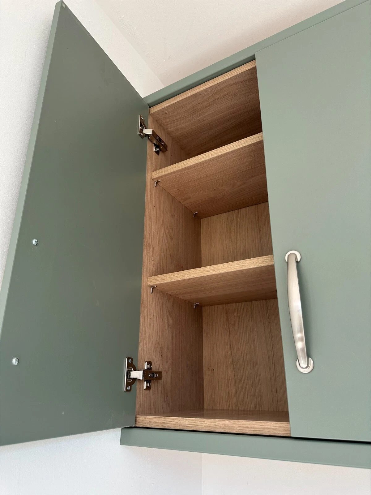 7.5m Modular Office – Kitchenette and Private Bathroom – open green cupboard with wood-effect interior and shelves